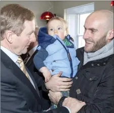  ??  ?? Taoiseach Enda Kenny is greeted by retired Sligo Rovers player, Alan Kean and his son, Dawson at the Avalon Centre in Sligo.