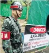  ??  ?? Police stand guard outside the Tham Luang cave complex after Thailand’s government instructed members of the media to move out urgently yesterday.