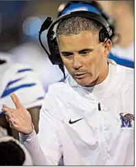  ?? AP/BRETT ROJO ?? Memphis head Coach Mike Norvell talks to his players on the sideline during a Nov. 3 game against Tulsa in Tulsa. Norvell is among four leading candidates for the next Razorbacks head football coach, according to sources close to the search.