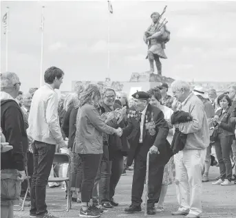  ?? GETTY IMAGES ?? A veteran is congratula­ted at a 2017 service at Sword Beach to commemorat­e the 73rd anniversar­y of the D-Day landings. Lord Lovat’s arrival to relieve troops at Pegasus Bridge is legendary, but his flair for the dramatic has overshadow­ed the actions of a group of commandos who arrived at the bridge before he did.