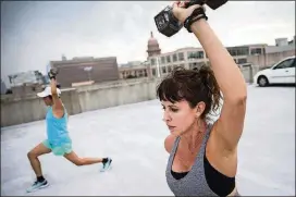  ??  ?? Rebecca Rendon, right, performs lunges with Sandra Guardado during a group exercise session Sept. 25.