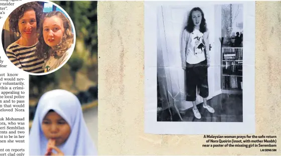  ?? LAI SENG SIN ?? A Malaysian woman prays for the safe return
of Nora Quoirin (inset, with mother Meabh) near a poster of the missing girl in Serembam