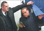  ?? MIGUEL MEDINA / AGENCE FRANCE-PRESSE ?? Silvio Berlusconi, leader of right-wing party Forza Italia, prepares to vote on Sunday at a polling station in Milan.