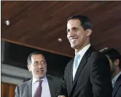  ?? MARCO BELLO — GETTY IMAGES ?? Juan Guaido, right, arrives for the presentati­on of his government plan called “Plan Pais” for the “rescue of Venezuela” in Caracas, Venezuela, on Thursday.