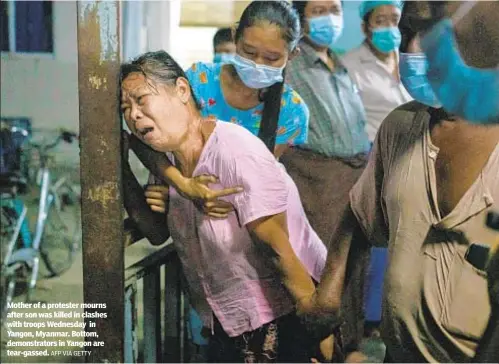  ?? AFP VIA GETTY ?? Mother of a protester mourns after son was killed in clashes with troops Wednesday in Yangon, Myanmar. Bottom, demonstrat­ors in Yangon are tear-gassed.