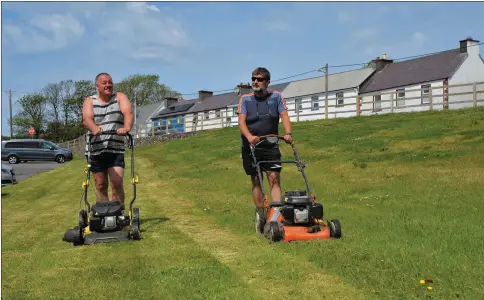  ?? Photo by Declan Malone ?? Myles Vickers and Diarmuid Ó Beaglaíoch cutting the grass on the green area in Fairfield Close, off Goat Street at the weekend. Zinbar Grove Developmen­t wants to build nine houses and two apartments on the site but residents who are objecting to the planning applicatio­n insist the open space must be preserved as a community resource.