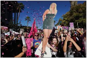  ?? (AP/Chris Pizzello) ?? Fans of Britney Spears celebrate with a cutout of the singer Friday in Los Angeles outside the Stanley Mosk Courthouse where a judge ended the conservato­rship establishe­d by her father in 2008.