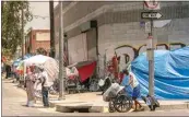  ?? DAMIAN DOVARGANES / AP, FILE ?? Tents line the streets of the Skid Row area of Los Angeles on July 22.