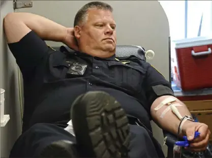  ?? Christian Snyder/ Post- Gazette ?? Pittsburgh police Chief Scott Schubert donates blood Wednesday in a Vitalant blood drive truck at the Pittsburgh police headquarte­rs on the North Side.