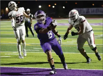  ?? PHOTO BY TRACEY ROMAN ?? St. Anthony's JoJo Apisala makes his way into the end zone for the Saints in their rout of La Salle on Friday night.