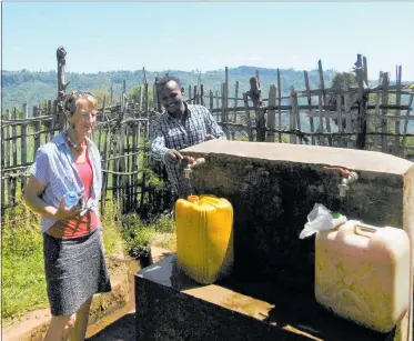  ??  ?? Barbara Stuckey in Ethiopia is shown a water station.