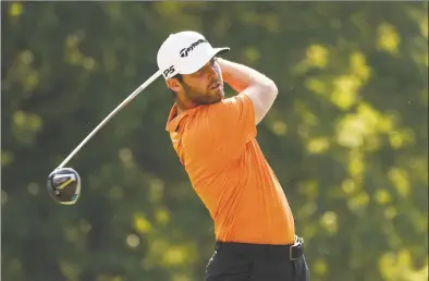  ?? Gregory Shamus / Getty Images ?? Matthew Wolff watches his tee shot on the 18th hole during the final round of the Rocket Mortgage Classic on Sunday at the Detroit Golf Club. Wolff finished second after starting the round with a three-shot lead.