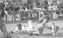  ??  ?? Diamondbac­ks catcher Jeff Mathis scores ahead of the tag by Padres catcher Austin Hedges during the seventh inning Tuesday.