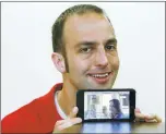  ?? JOHN GREEN/ STAFF ?? Evergive CEO and co- founder James Ioannidis shows the Evergive website on a phone at the company’s office in Palo Alto on Wednesday. Evergive is a social network, launched last month, for organizati­ons such as churches and nonprofits.