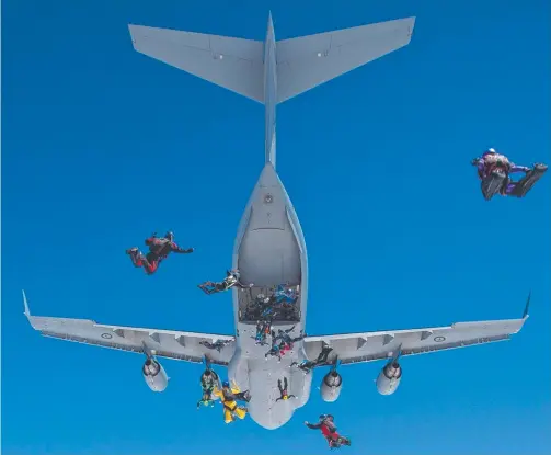  ??  ?? Two groups of 15 people jumped from an RAAF C17 Globemaste­r during World Parachutin­g Championsh­ips opening celebratio­ns.