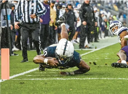  ?? BARRY REEGER/AP ?? Penn State running back Nicholas Singleton dives short of the goal line during the first half against Northweste­rn on Saturday in State College. The 11th-ranked Nittany Lions won 17-7.