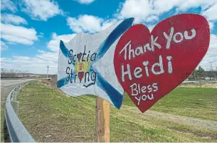  ?? ANDREW VAUGHAN THE CANADIAN PRESS FILE PHOTO ?? A memorial pays tribute to RCMP Const. Heidi Stevenson along the highway in Shubenacad­ie, N.S. in May. She was one of 22 people killed by a shooter in northern Nova Scotia in April.