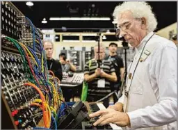  ?? Daniel Knighton WireImage ?? MUSIC INNOVATOR Malcolm Cecil plays a Moog synthesize­r at an Anaheim trade show in 2015. The synth expert helped lead an electronic­s revolution in pop music.