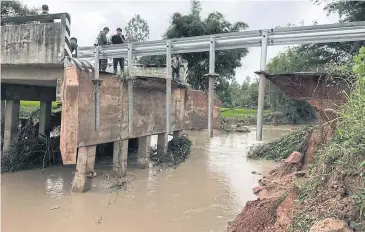  ??  ?? TROUBLED WATERS: Officials plan repairs to a damaged bridge in Ban None Sri Charoen in Na Mon district of Kalasin yesterday.