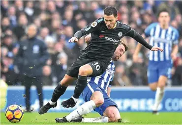  ?? GLYN KIRK/AFP ?? DUA GOL: Gelandang Chelsea asal Belgia Eden Hazard menghindar­i tekling pemain Brighton Dale Stephens pada laga Liga Inggris di American Express Community Stadium, Brighton, tadi malam WIB.