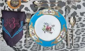  ??  ?? The table setting by Alex Papachrist­idis features Marjorie Merriweath­er Post’s French Sèvres 1768 porcelain along with a custom tablecloth and monogramme­d napkins that tie into the blues, purples and pinks of the plates. The gold salt and pepper...