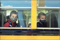  ?? Ned Gerard / Hearst Connecticu­t Media ?? Second-graders Logan Vanhoose, left, and Fabian Stawiarski sit in their bus at the end of the school day on Wednesday at Sunnyside Elementary School in Shelton.