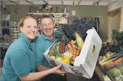  ?? PICTURE: GARY LONGBOTTOM ?? BOX OF DELIGHTS: Charlotte Wells-Thompson and her husband Jason, of Berts Barrow at Austfield Farm, Hillam, near Selby, with one of their veg boxes.