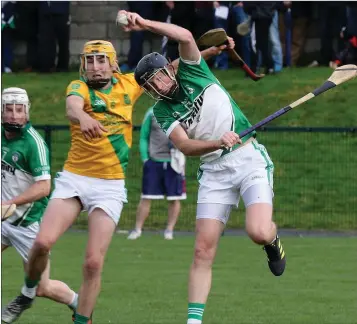  ??  ?? M.J. Furlong (Cloughbawn) beats Podge Doyle (Shamrocks) to the ball with a spectacula­r leap.