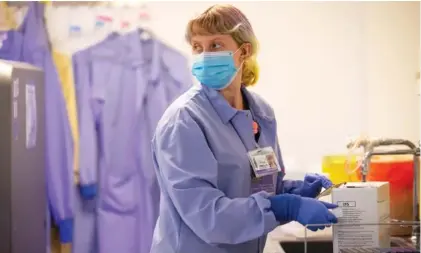  ?? ERIKA SCHULTZ/THE SEATTLE TIMES VIA AP, POOL ?? Medical laboratory scientist Mallory O’Malley processes COVID-19 tests at the University of Washington Medicine Virology Lab in Seattle on Monday.