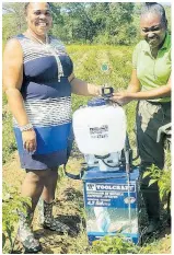  ?? ?? After receiving prizes from Natanish Hines (left), 4-H Parish Manager for Trelawny for being the best young farmer in the parish, Osbourne was last week named All-Island Youth Farmer at the Jamaica 4-H Clubs National Achievemen­t Expo 2022.