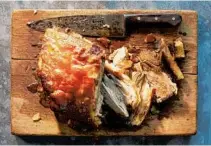 ??  ?? Pernil is a sumptuous preparatio­n for pork shoulder that is marinated in garlic, citrus and herbs, then slow-roasted on high heat to achieve a crisp chicharron, or skin.