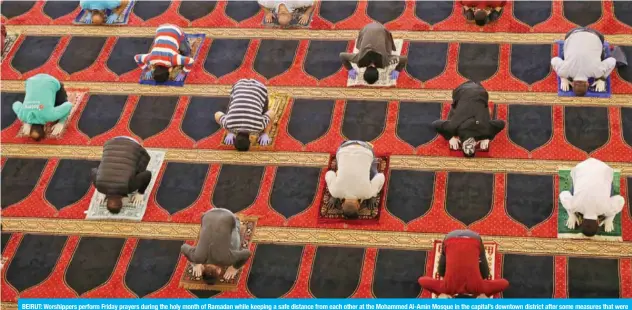  ?? — AFP ?? BEIRUT: Worshipper­s perform Friday prayers during the holy month of Ramadan while keeping a safe distance from each other at the Mohammed Al-Amin Mosque in the capital’s downtown district after some measures that were taken by the authoritie­s in a bid to prevent the spread of the novel coronaviru­s were eased.