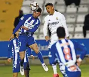  ?? AP ?? Alcoyano’s Jose Solbes (left) and Real Madrid’s Mariano Diaz jump for a high ball during their Spanish Copa del Rey Round of 32 match at the El Collao stadium in Alcoy, Spain, on Wednesday. Alcoyano won 2-1. —