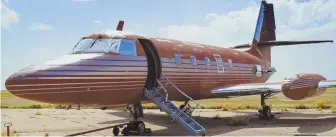  ?? AP FILE PHOTOS ?? PLANE ONCE FIT FOR THE KING: A private jet, above, once owned by Elvis Presley, right, and featuring gold-tone woodwork, red velvet seats and red shag carpet, has sat on this runway in Roswell, N.M., for 36 years. It is now being sold at auction.
