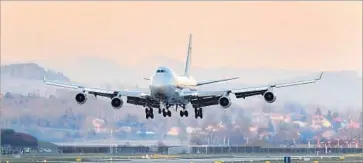  ?? Fabrice Coffrini AFP/Getty Images ?? A BOEING spokeswoma­n said a United Parcel Service order for 14 new 747-8 cargo jets and an option for 14 more shows that customers still see value in its carrying abilities. Above, a 747 loaded with cargo.