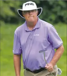  ?? Drew Hallowell/Getty Images ?? Kirk Triplett watches his ball on the 18th green in the second round of the U.S. Senior Open Championsh­ip. Triplett is tied with Kenny Perry for the lead at 11 under.