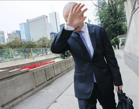  ?? FRANK GUNN/THE CANADIAN PRESS ?? Sears Canada chief financial officer Billy Wong walks away from the Ontario Superior Court in Toronto on Thursday. Sears Canada got the green light for the sale and investor solicitati­on process. It also reached a deal to extend benefit and pension...