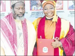  ??  ?? •Mufti, Conference of Islamic Organisati­ons (CIO) Sheikh Dhikrullah Shafi’i with his daughter, Labeebah Dhikrullah, who bagged First Class in Marine Sciences at the University of Lagos during the convocatio­n in Akoka, Lagos.