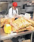  ?? AP PHOTO ?? Mick Zalis oversees preparatio­ns for a Thanksgivi­ng dinner to be served for people displaced by the Northern California Camp wildfire on the campus of California State University.