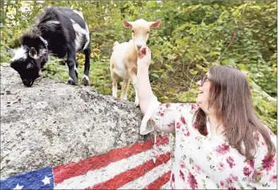  ?? Peter Hvizdak / Hearst Connecticu­t Media ?? Dannielle Sidaoui, of Guilford, with her two playful Nigerian goats on Friday. George, the tan-colored male, and Misty, the dappled black and white female, are siblings.