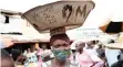  ?? | EPA ?? A WOMAN wears a mask at a food market in Lagos this week.