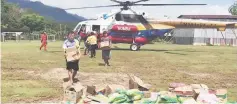  ??  ?? Fire and Rescue personnel help to unload food items from a helicopter for the flood victims in Long Sobeng, Tinjar. Photo courtesy of Miri Zone Fire chief, Senior Fire Superinten­dent Law Poh Kiong.