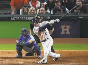  ?? Michael Ciaglo / Houston Chronicle ?? Houston’s Alex Bregman connects for a single to left off Kenley Jansen, driving in pinch-runner Derek Fisher with the winning run in the 10th inning of Game 5.