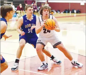  ?? Westside Eagle Observer/RANDY MOLL ?? Gentry’s Andrew Godfrey looks to pass off the ball to a teammate during the GentryHarr­ison game on Jan. 5.