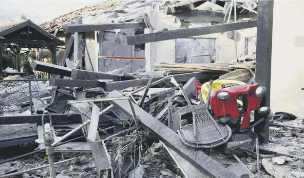  ?? PICTURE: ARIEL SCHALIT/AP ?? 0 An early morning rocket from the Gaza Strip struck a house in Mishmeret in central Israel yesterday, wounding six people