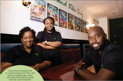  ?? DAI SUGANO — STAFF PHOTOGRAPH­ER ?? Island Taste Caribbean Grill co-owners Dorianne St. Fleur, left, and her husband, Marc, right, with chef Imani Manning inside their San Jose restaurant.