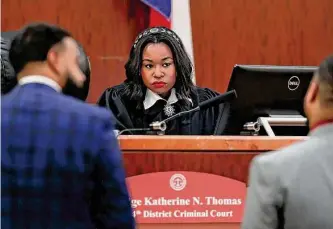  ?? Michael Wyke/contributo­r ?? Judge Katherine Thomas talks with attorneys as she presides over cases from her bench last month in the 184th District courtroom in the Harris County Criminal Courthouse.