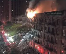  ?? MATT BONACCORSO, AP ?? Firefighte­rs work to put out a blaze early Thursday at an apartment building on New York’s Upper East Side. One person was killed in the six-alarm fire.