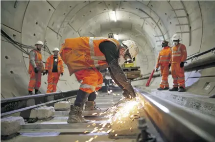  ?? PHOTOGRAPH: DAN KITWOOD/GETTY IMAGES ?? ▲ Workers on the Crossrail line in London. There was a year-on-year fall in public borrowing in 2023-24