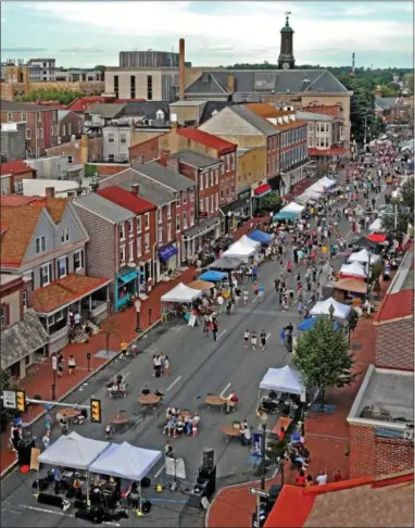  ??  ?? A crowd gathers for the 33rd annual Chester County Restaurant Festival on Sunday in downtown West Chester. Gay Street and Market Street were blocked off for this year’s event.